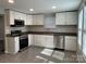 Modern kitchen with stainless steel appliances, granite countertops, and ample cabinet space at 1404 Lineberger Ave, Gastonia, NC 28052