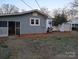 Spacious backyard with partial view of house, screen door, grill, and basketball hoop on a sunny day at 1426 E Council St, Salisbury, NC 28146