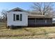 Back exterior view of home showcasing neutral siding and a partially screened-in porch and spacious backyard at 1426 E Council St, Salisbury, NC 28146