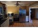 Eat-in kitchen features stainless steel appliances, contrasting cabinets, and hardwood flooring throughout at 1426 E Council St, Salisbury, NC 28146