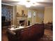 Inviting living room featuring a decorative fireplace, hardwood floors, and a comfortable leather sofa at 1426 E Council St, Salisbury, NC 28146