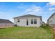 A well-manicured backyard with healthy green grass and a cozy white house in the background at 1529 Pebble Shore Ln # 164, Belmont, NC 28012