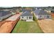 Overhead view of a single-Gathering home's backyard with a concrete patio, expansive lawn, and AC unit at 1529 Pebble Shore Ln # 164, Belmont, NC 28012