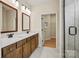 Bathroom featuring a double vanity with modern fixtures and a walk-in shower with glass door at 1529 Pebble Shore Ln # 164, Belmont, NC 28012