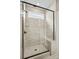 Modern tiled shower with glass enclosure, shower bench, and black trim at 1529 Pebble Shore Ln # 164, Belmont, NC 28012