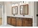 Bathroom featuring a double vanity with modern fixtures, quartz countertops, and wooden cabinets at 1529 Pebble Shore Ln # 164, Belmont, NC 28012