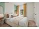 This bedroom features a neutral color palette, a large window with natural light and stylish decor, and a comfortable modern bed at 1529 Pebble Shore Ln # 164, Belmont, NC 28012