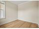 A bright bedroom with light colored walls, clean white trim, and beautiful vinyl flooring throughout at 1529 Pebble Shore Ln # 164, Belmont, NC 28012