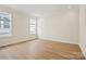 Well-lit bedroom featuring spacious layout with hardwood floors and large windows, creating a peaceful retreat at 1529 Pebble Shore Ln # 164, Belmont, NC 28012