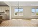 An open dining area with vinyl floors boasts bright light and easy access to a modern kitchen at 1529 Pebble Shore Ln # 164, Belmont, NC 28012
