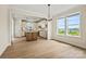 An airy dining room filled with natural light and vinyl flooring that flows seamlessly into the modern kitchen at 1529 Pebble Shore Ln # 164, Belmont, NC 28012