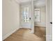 Bright entryway featuring a white front door with glass panels and durable vinyl flooring throughout the space at 1529 Pebble Shore Ln # 164, Belmont, NC 28012