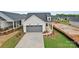 Charming single-Gathering home with a grey garage door, manicured lawn, and inviting curb appeal at 1529 Pebble Shore Ln # 164, Belmont, NC 28012