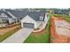 Beautiful single-Gathering home with a grey garage door, new landscaping, and manicured lawn at 1529 Pebble Shore Ln # 164, Belmont, NC 28012