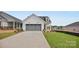 Inviting single-Gathering home with a grey garage door, landscaped yard, and covered entry at 1529 Pebble Shore Ln # 164, Belmont, NC 28012