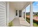Covered front porch features white columns, window, and a black front door at 1529 Pebble Shore Ln # 164, Belmont, NC 28012