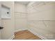 Walk-in closet with hardwood floors and wire shelving, ready for personalized organization at 1529 Pebble Shore Ln # 164, Belmont, NC 28012