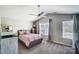 Bright bedroom with vaulted ceilings, a ceiling fan, two windows, and a comfortable bed with pink bedding at 1614 Harland St, Charlotte, NC 28216