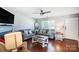 Bright living room with window, ceiling fan, and hardwood floors at 1614 Harland St, Charlotte, NC 28216