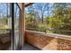 Balcony showing brick and iron railing with treetop views at 224 N Poplar St # 9, Charlotte, NC 28202
