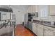Kitchen features stainless steel refrigerator, sink, granite countertops, and wooden floors at 224 N Poplar St # 9, Charlotte, NC 28202