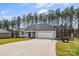 View of a single Gathering house with an attached garage and a large paved driveway at 2621 Marble St, Newton, NC 28658