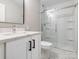 Bathroom features white vanity with dark hardware and shower with glass doors at 2628 Park Rd # F, Charlotte, NC 28209