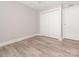 Empty bedroom features light colored walls, flooring, and white doors at 2628 Park Rd # F, Charlotte, NC 28209