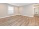 This spacious bedroom features new luxury vinyl plank flooring and a large window that provides natural light at 2628 Park Rd # F, Charlotte, NC 28209