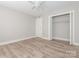 Bedroom with closet, ceiling fan, light gray walls, and light wood-look floors at 2628 Park Rd # F, Charlotte, NC 28209