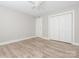 Bedroom with light gray walls, light wood-look floors, and a closet with closed doors at 2628 Park Rd # F, Charlotte, NC 28209