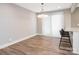 Bright dining area features a modern light fixture, access to the outdoor living area, and luxury vinyl plank flooring at 2628 Park Rd # F, Charlotte, NC 28209