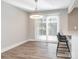 Bright dining area features a modern light fixture, access to the outdoor living area, and luxury vinyl plank flooring at 2628 Park Rd # F, Charlotte, NC 28209