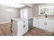 Bright kitchen features white cabinets, stainless steel appliances, and stone countertops at 2628 Park Rd # F, Charlotte, NC 28209