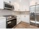 Bright kitchen features white cabinets, stainless steel appliances, and stone countertops at 2628 Park Rd # F, Charlotte, NC 28209
