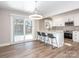 Modern kitchen with white cabinetry, stainless steel appliances, subway tile backsplash and breakfast bar with seating at 2628 Park Rd # F, Charlotte, NC 28209