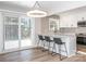 Modern kitchen with white cabinetry, stainless steel appliances, subway tile backsplash and breakfast bar with seating at 2628 Park Rd # F, Charlotte, NC 28209