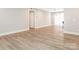 Open concept living area features luxury vinyl plank flooring and is connected to the dining area and kitchen at 2628 Park Rd # F, Charlotte, NC 28209