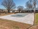 Exterior view of the community pool with surrounding trees and grassy area at 2628 Park Rd # F, Charlotte, NC 28209