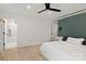 Bedroom with an ensuite bathroom and gray accent wall with mounted lighting and ceiling fan at 3009 Rockingham Sw Ct, Concord, NC 28025