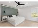 Modern bedroom with a platform bed, gray accent wall with lighting, and a ceiling fan at 3009 Rockingham Sw Ct, Concord, NC 28025