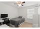 Cozy bedroom with neutral tones, hardwood floors, and ample natural light at 3009 Rockingham Sw Ct, Concord, NC 28025