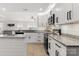 This kitchen offers stainless steel appliances, granite countertops, and stylish white cabinetry at 3009 Rockingham Sw Ct, Concord, NC 28025