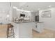 Modern kitchen features granite countertops, white cabinets, stainless steel appliances, and breakfast bar at 3009 Rockingham Sw Ct, Concord, NC 28025