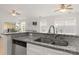 Kitchen view showcasing granite countertops, stainless steel sink, and open layout to living area at 3009 Rockingham Sw Ct, Concord, NC 28025