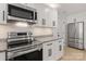 Updated kitchen features stainless steel appliances, subway tile backsplash, and granite countertops at 3009 Rockingham Sw Ct, Concord, NC 28025
