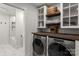 Laundry room with a washer, dryer, butcher block countertop and shelving at 3009 Rockingham Sw Ct, Concord, NC 28025
