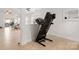 Open-concept living space with hardwood floors and an exercise machine at 3009 Rockingham Sw Ct, Concord, NC 28025