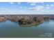 Expansive aerial view of a lake with lush islands and surrounding residential areas at 302 Ambleside Village Ln, Davidson, NC 28036