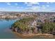 Stunning aerial view of lakeside residences surrounded by lush greenery and tranquil waters at 302 Ambleside Village Ln, Davidson, NC 28036
